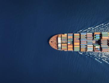 Cargo ship traveling on open water.