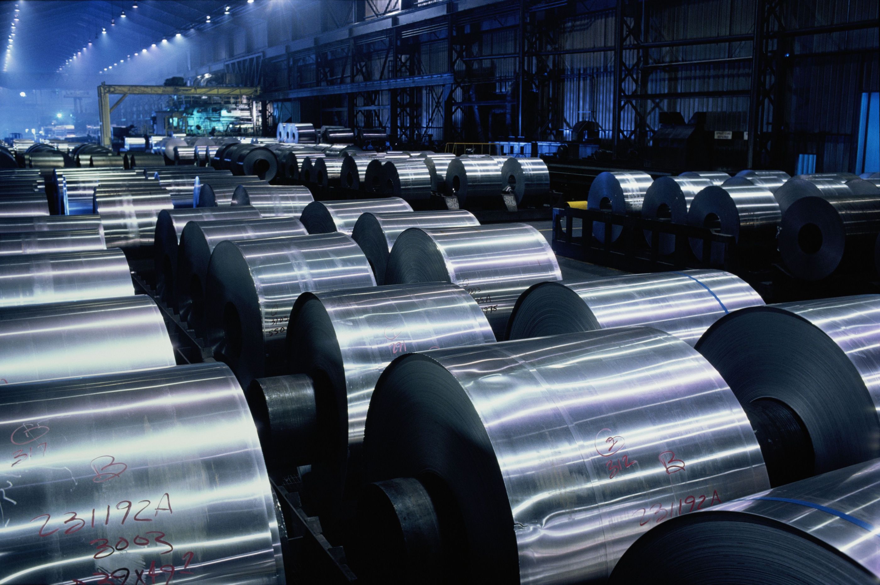 Rolls of aluminum sheeting on factory floor