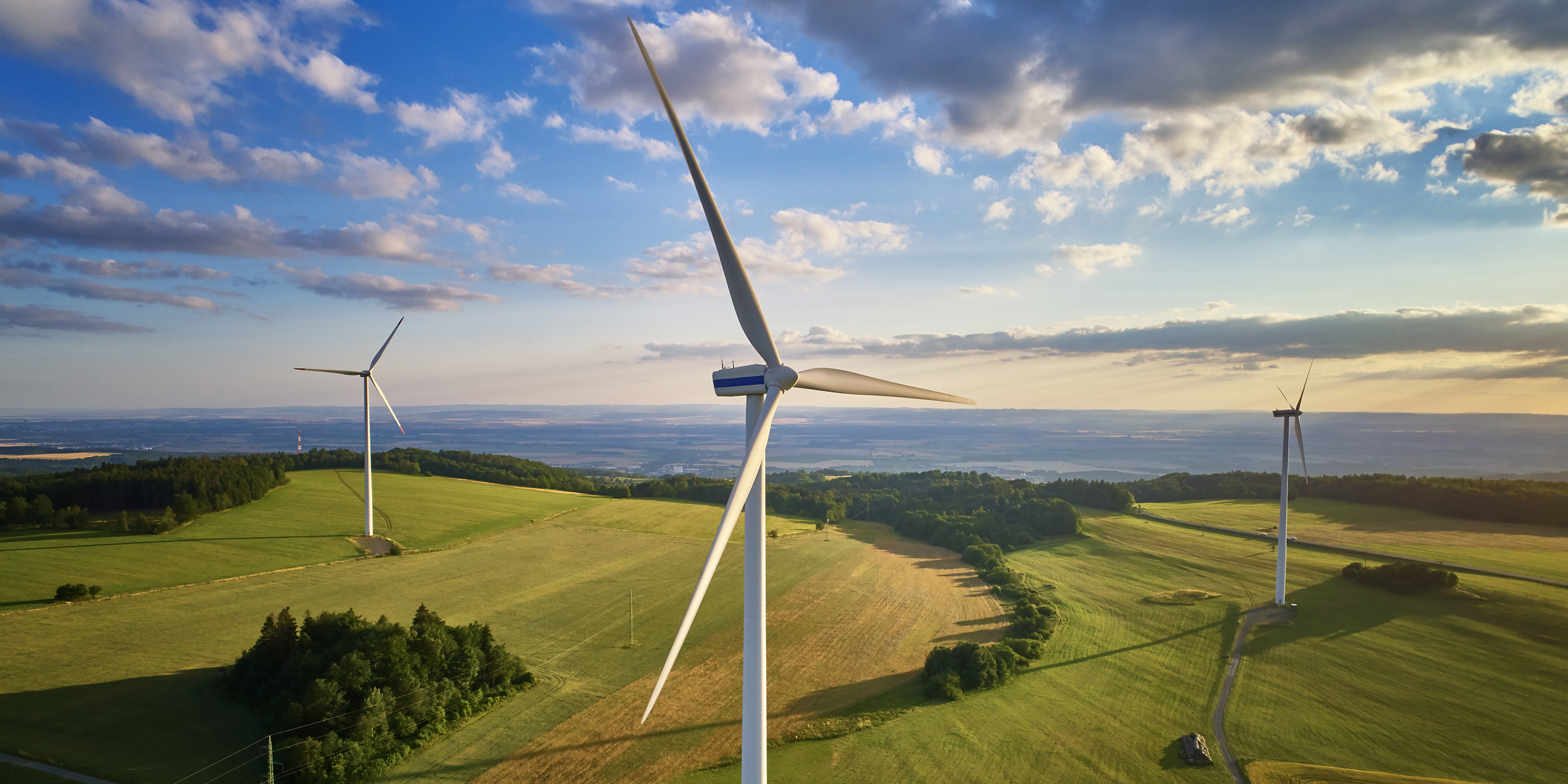 Wind turbines on grassy fields.