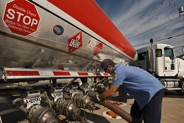 Worker filling oil tank