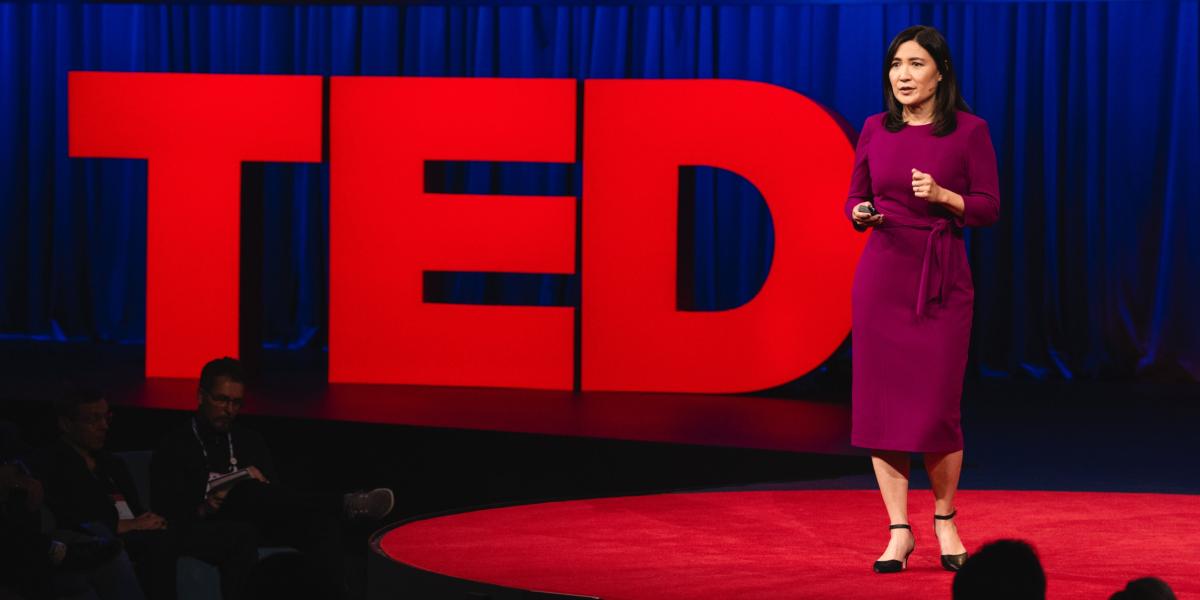 Millie Chu Baird on stage giving a TED Talk about the fastest way to slow global warming