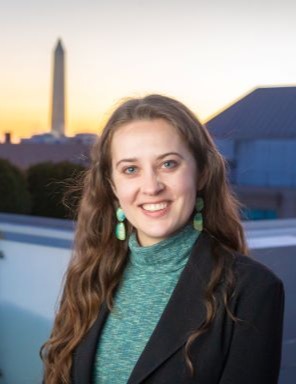 photo of Emily outside at sunset with the Washington Monument in the background