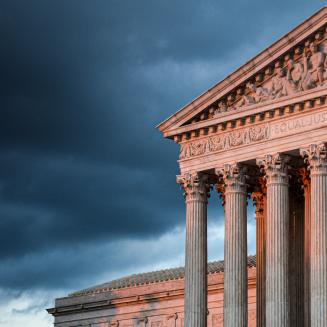 Supreme Court of the United States building with storm clouds