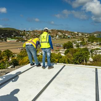 Solar installers on the roof of Roberto Rexach's home in Culebra, Puerto Rico