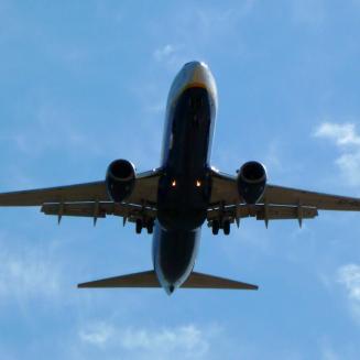 An airplane inflight viewed from below.
