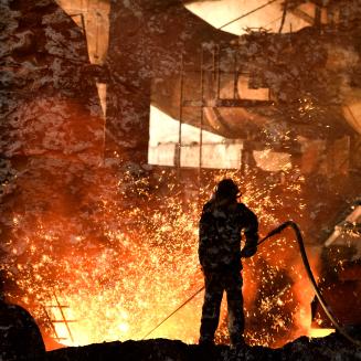 Steelworker working with very hot materials, amidst sparks.