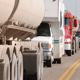 A row of trucks on a crowded road