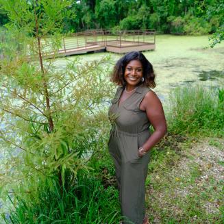 Rashida Ferdinand standing near a wetland.