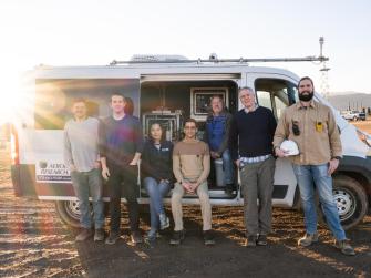 Seven researchers stand in front of a research van used in field tests to detect hydrogen leaks.