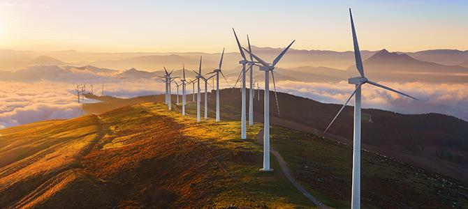 Line of wind turbines on a hilltop